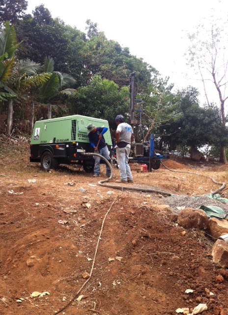 Agua Viva staff members Enrique and Jeremiah setting at the drill site.