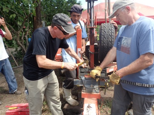 Don Davis and Mike Aronson repairing broken chain on drill rig.